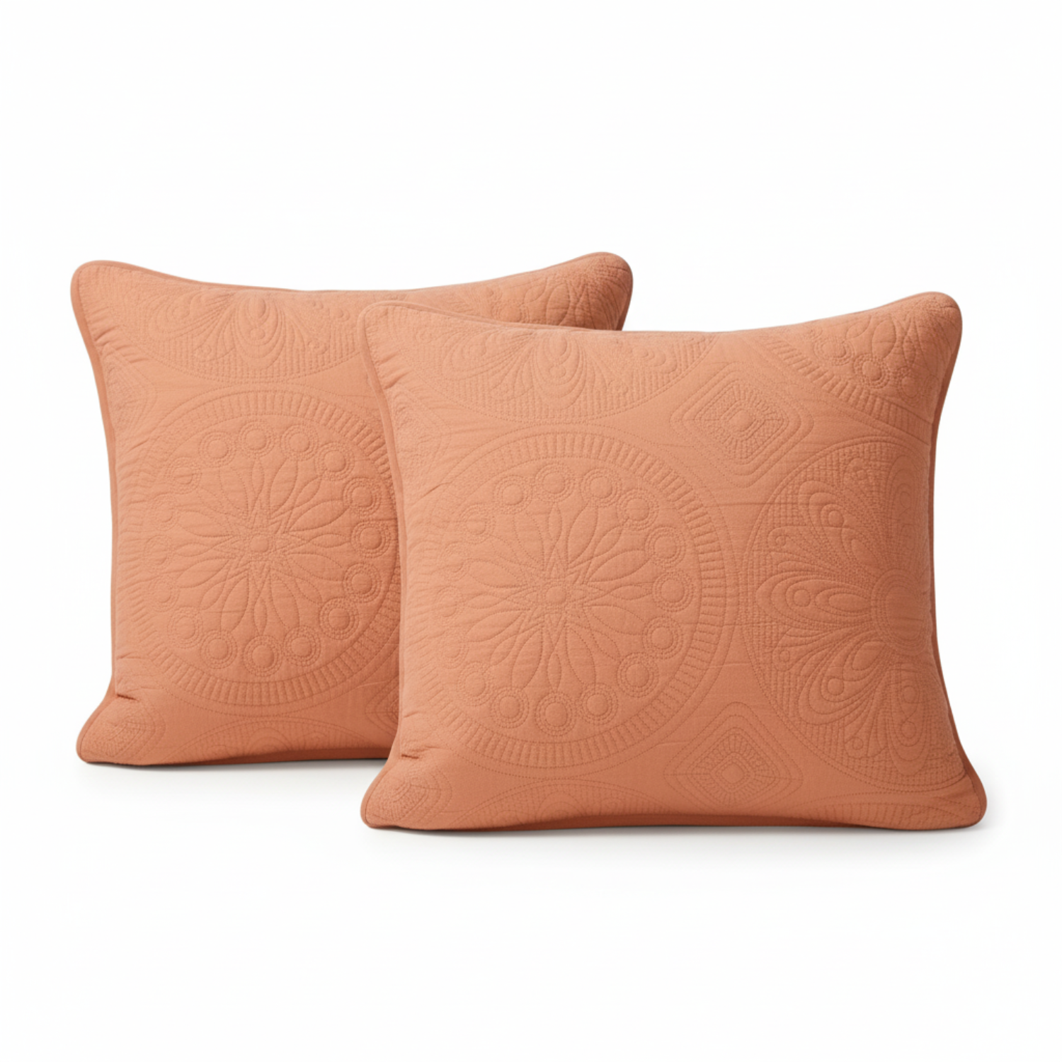 Two terracotta-colored decorative pillows with intricate patterns on a white background