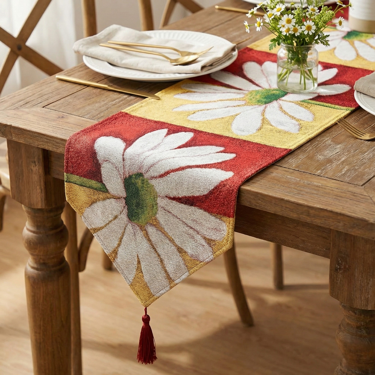 Dining table set with a floral table runner, plates, and cutlery.