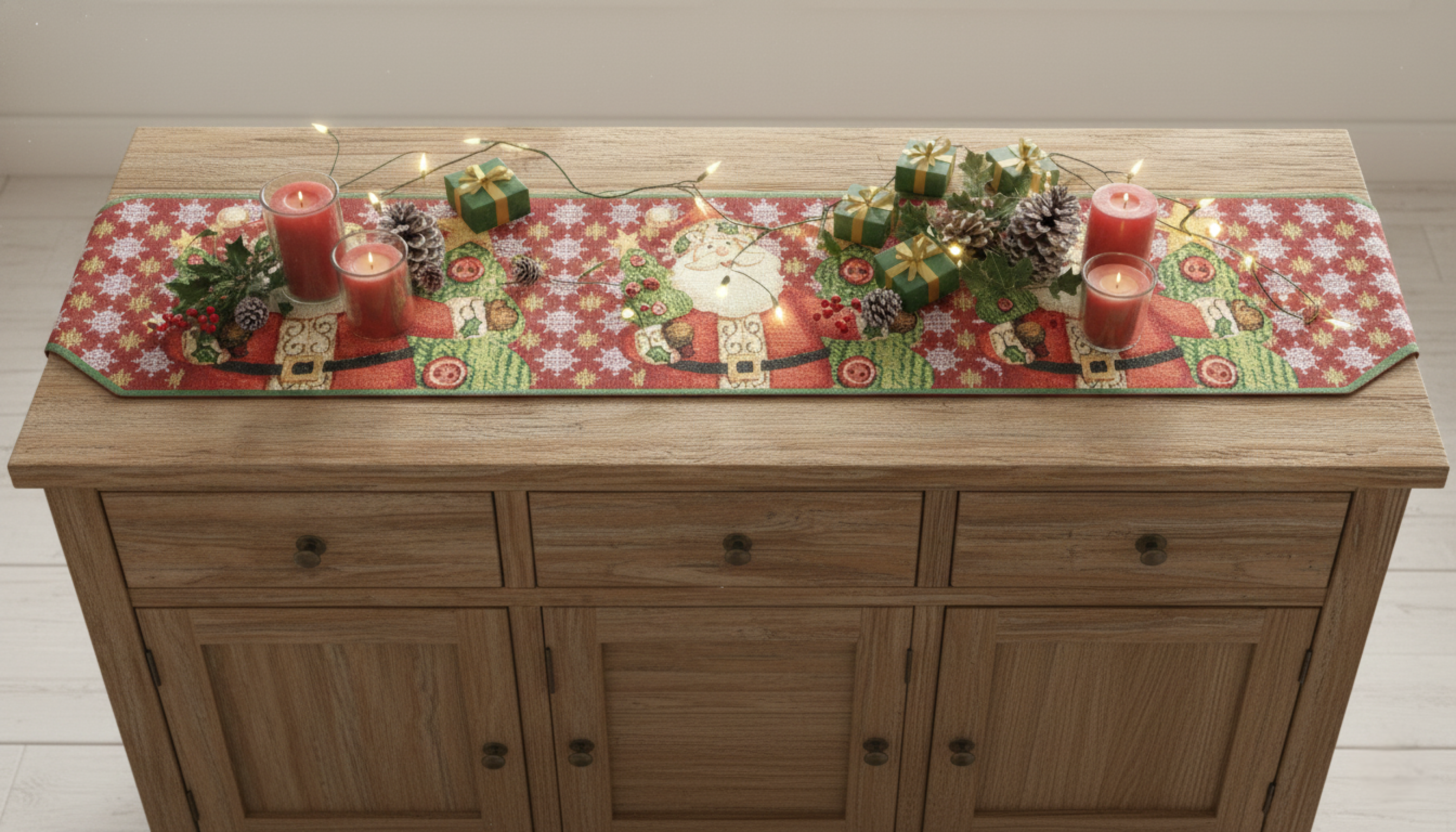 Wooden sideboard with a decorative Christmas table runner, candles, and small gifts on a light wooden floor.