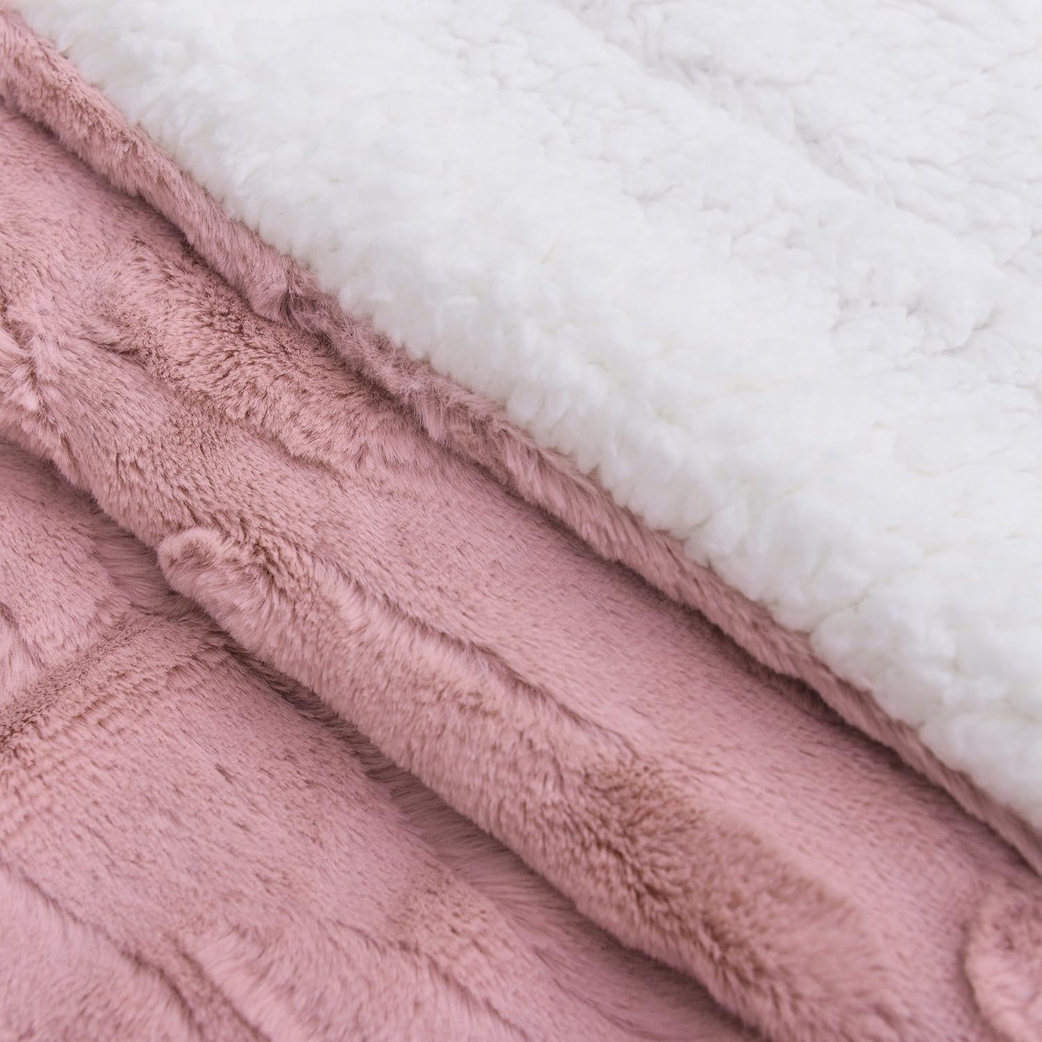 Invite relaxation with a faux fur throw blanket. Rose Pink faux fur front and white sherpa back side