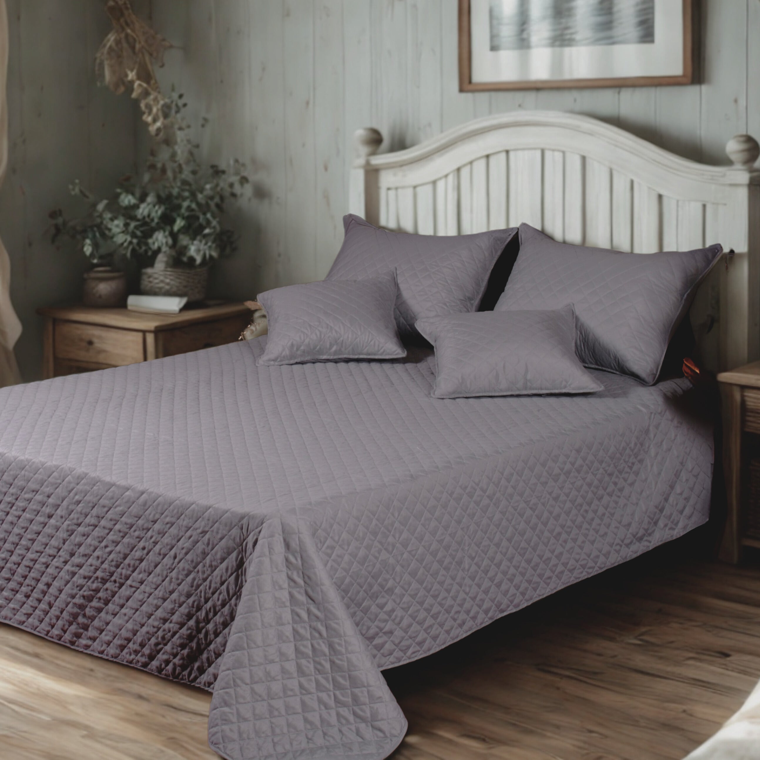 Elegant bedroom with a cozy, quilted gray bedspread set, featuring a diamond-stitched pattern and matching pillow shams, styled on a rustic wooden bed with a white headboard and natural wood nightstands