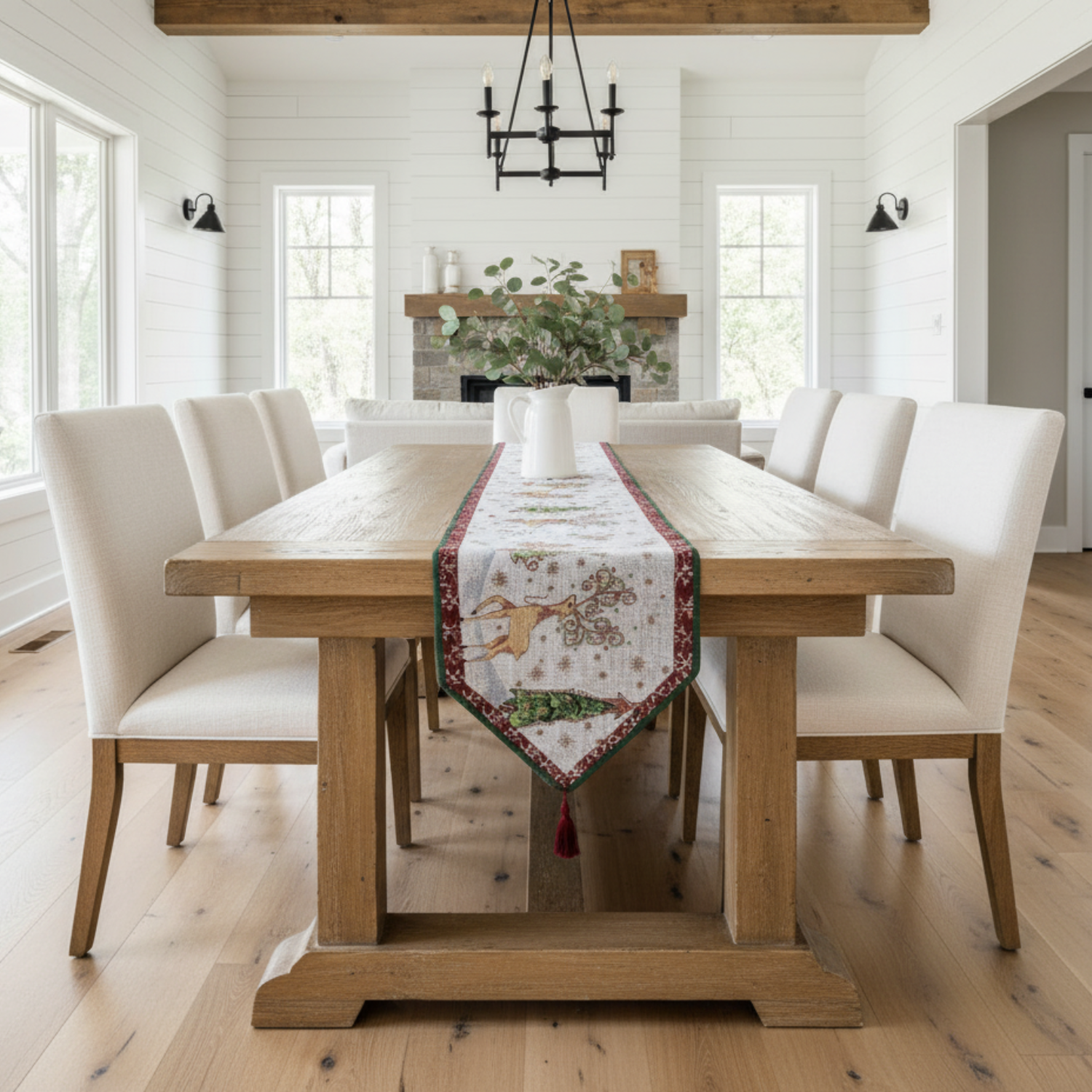 Dining room with wooden table and chairs, decorated with a festive table runner.