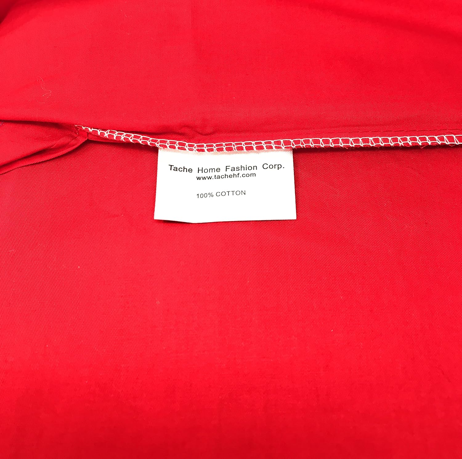 Red fabric with a label from Tache Home Fashion Corp.