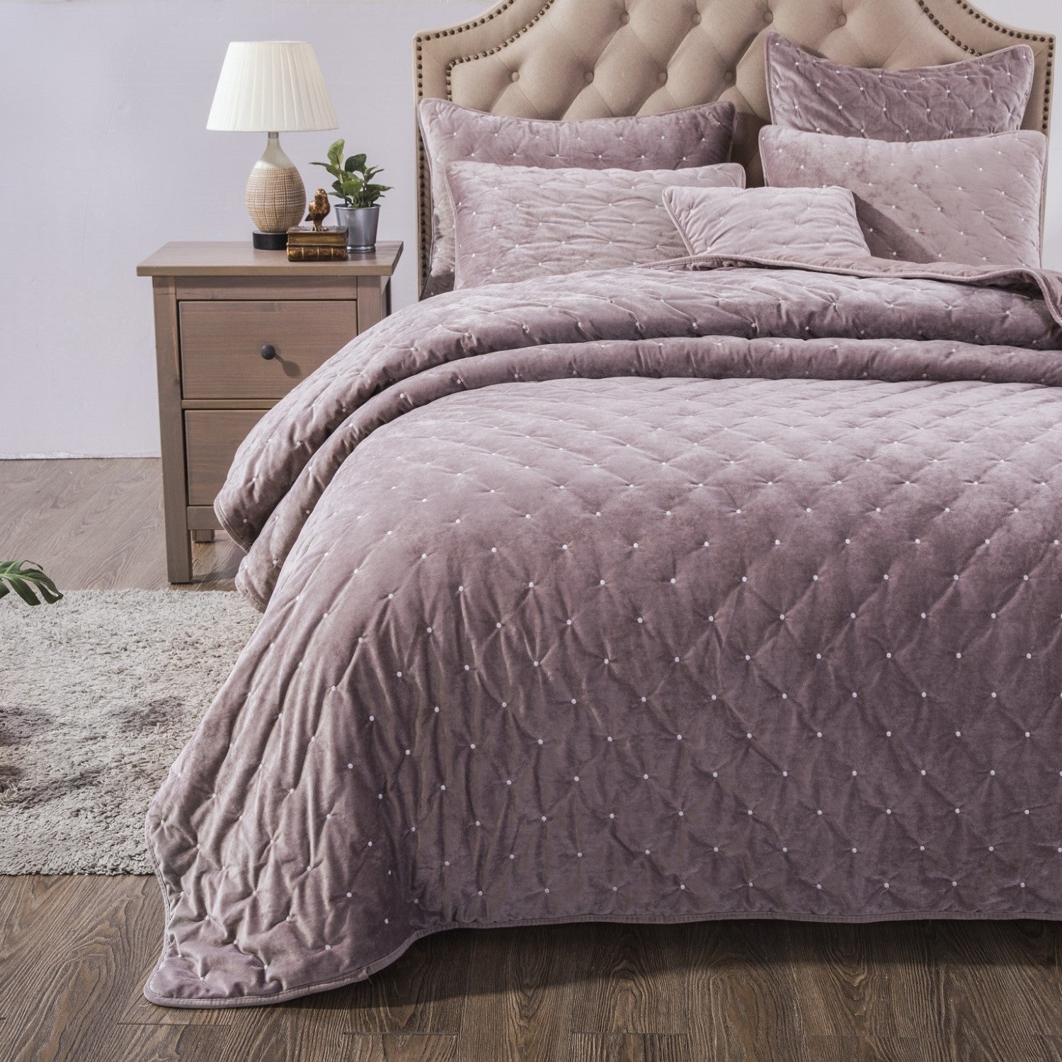 Tache Plush Dreams Purple Mauve Tufted Velvet Quilt Set Purple quilted bedspread on a bed with matching pillows in a bedroom setting.