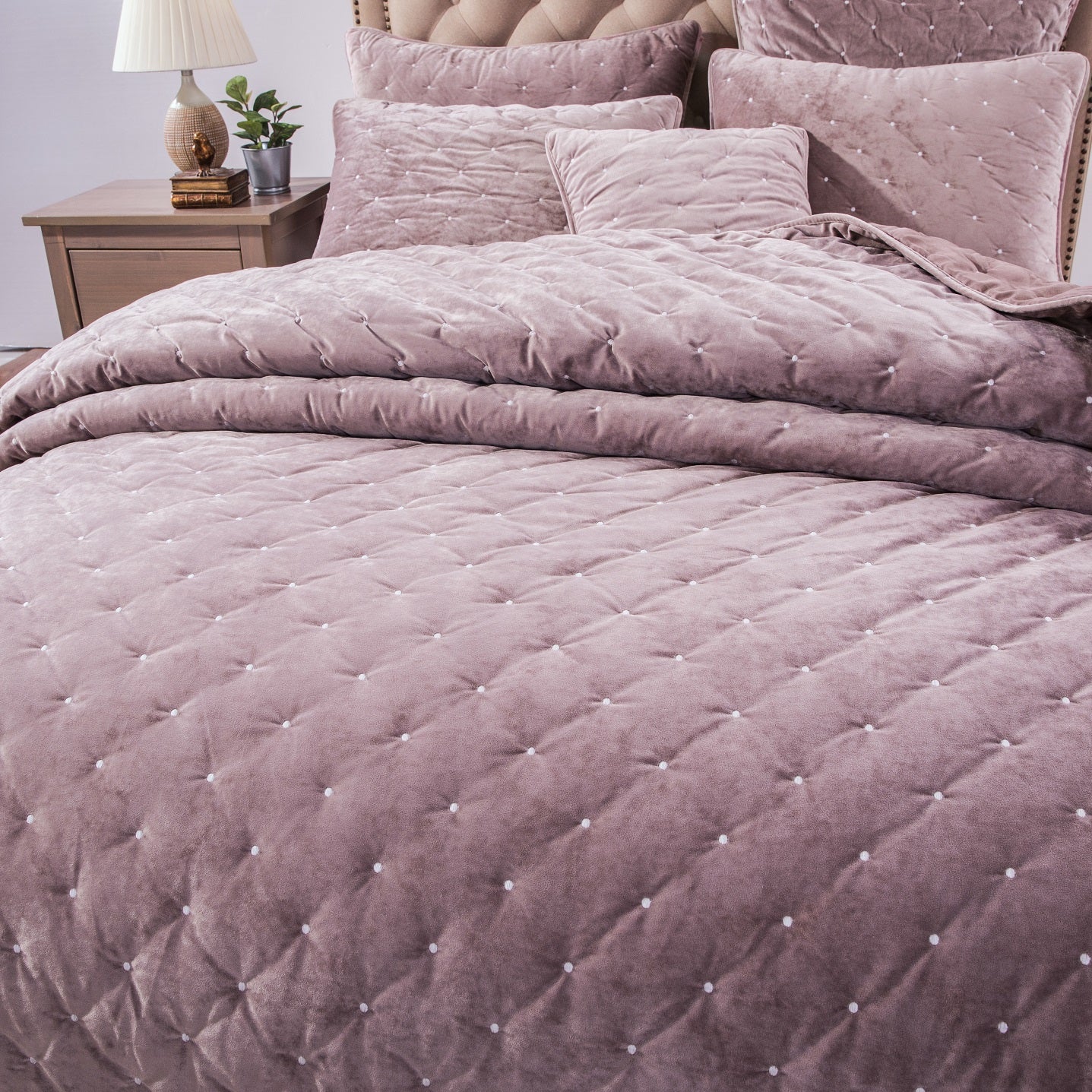 Tache Plush Dreams Purple Mauve Tufted Velvet Quilt Set Quilted purple comforter on a bed with matching pillows, in a bedroom setting.