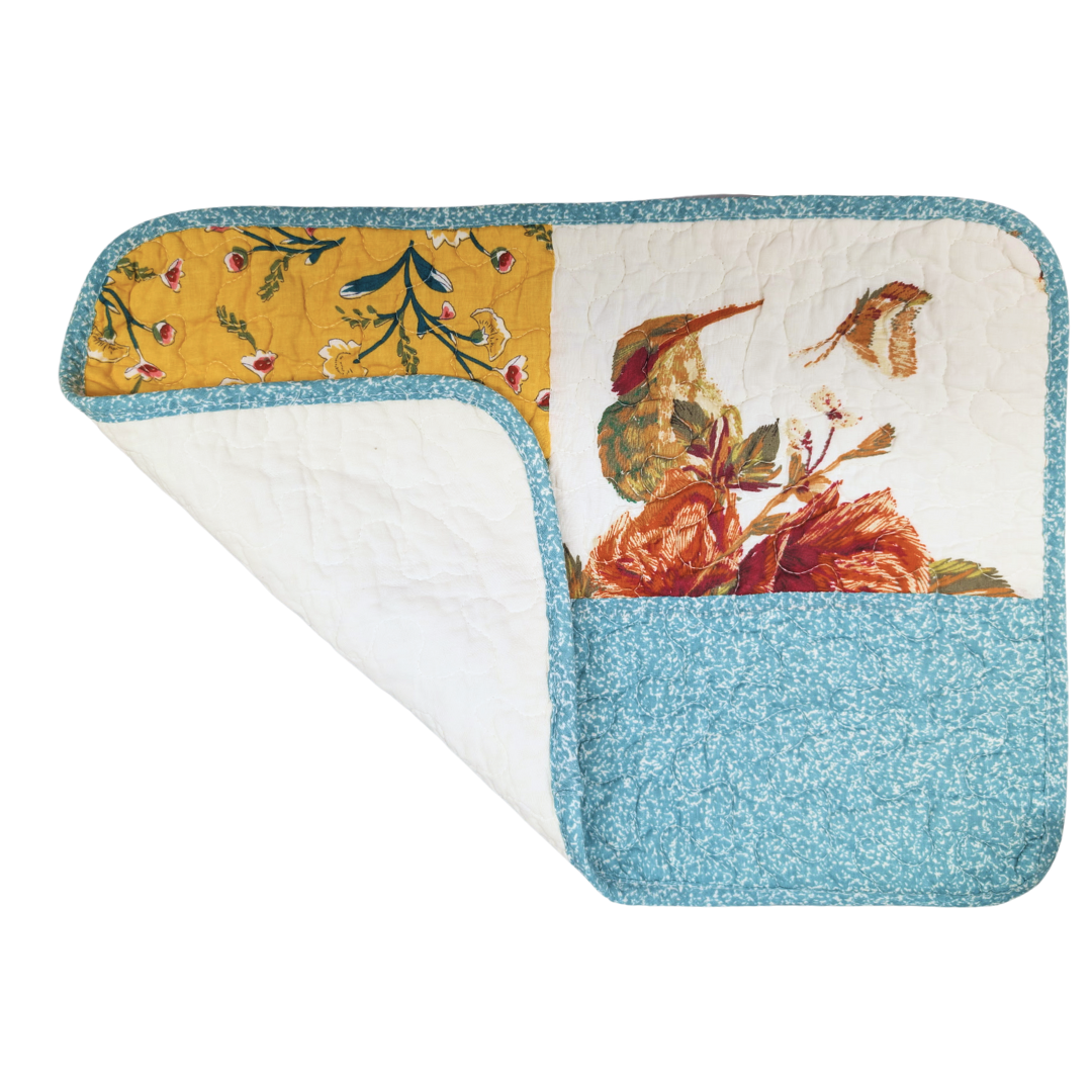 Decorative rug with floral and bird pattern on a white background