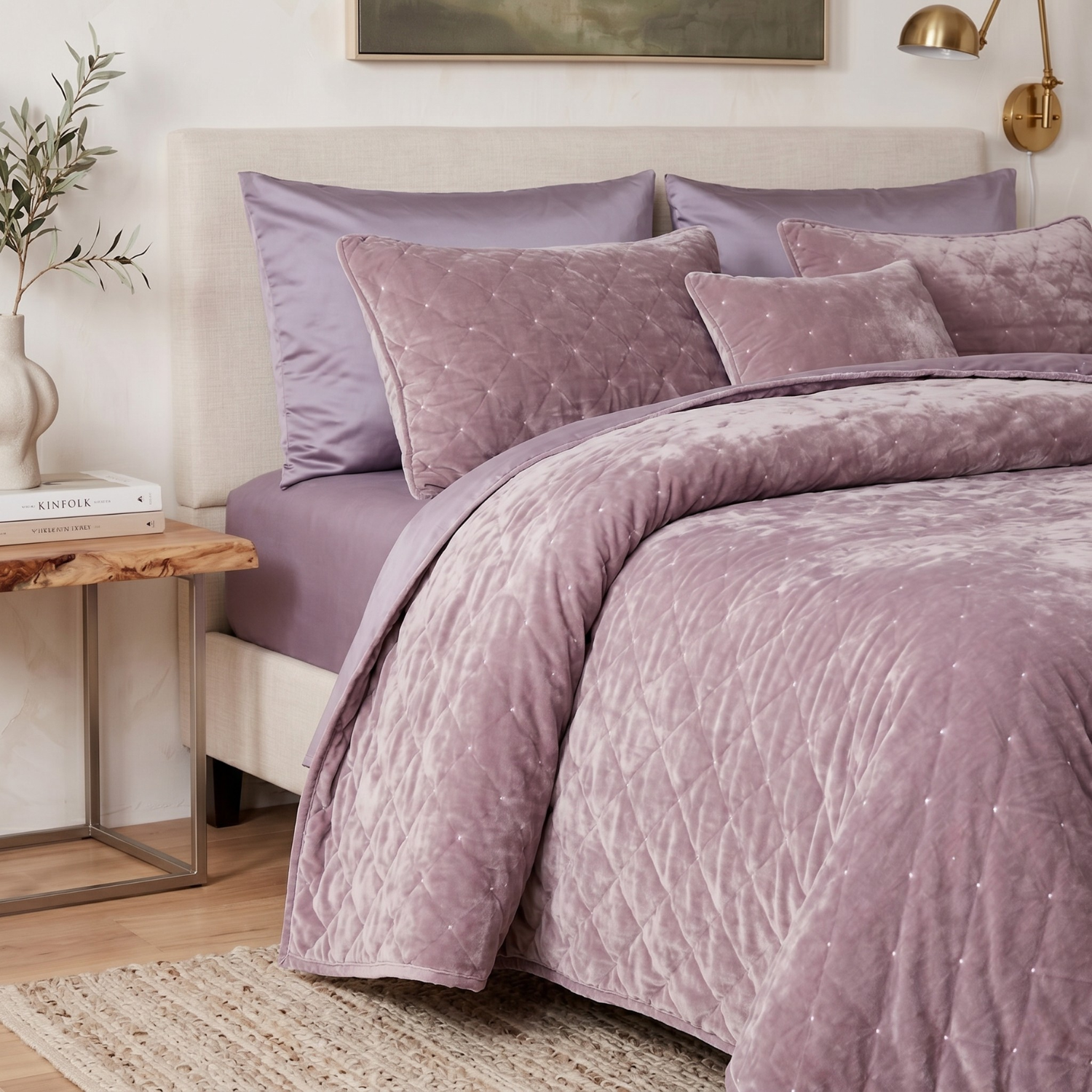 Tache Home Fashion purple mauve tufted velvet quilt set arranged on a bed, complete with matching bed sheets and pillow shams in a cozy bedroom.