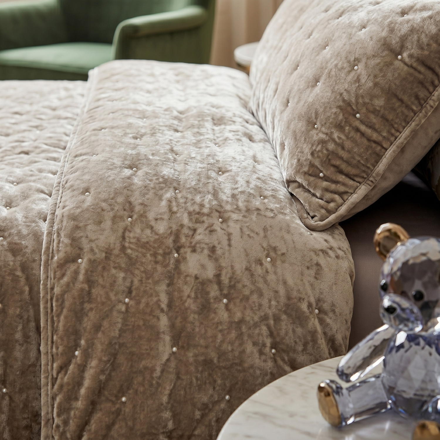 Luxurious sand taupe beige diamond tufted velvet bedspread set with matching shams, styled in a modern bedroom with a storage bench and elegant decor.