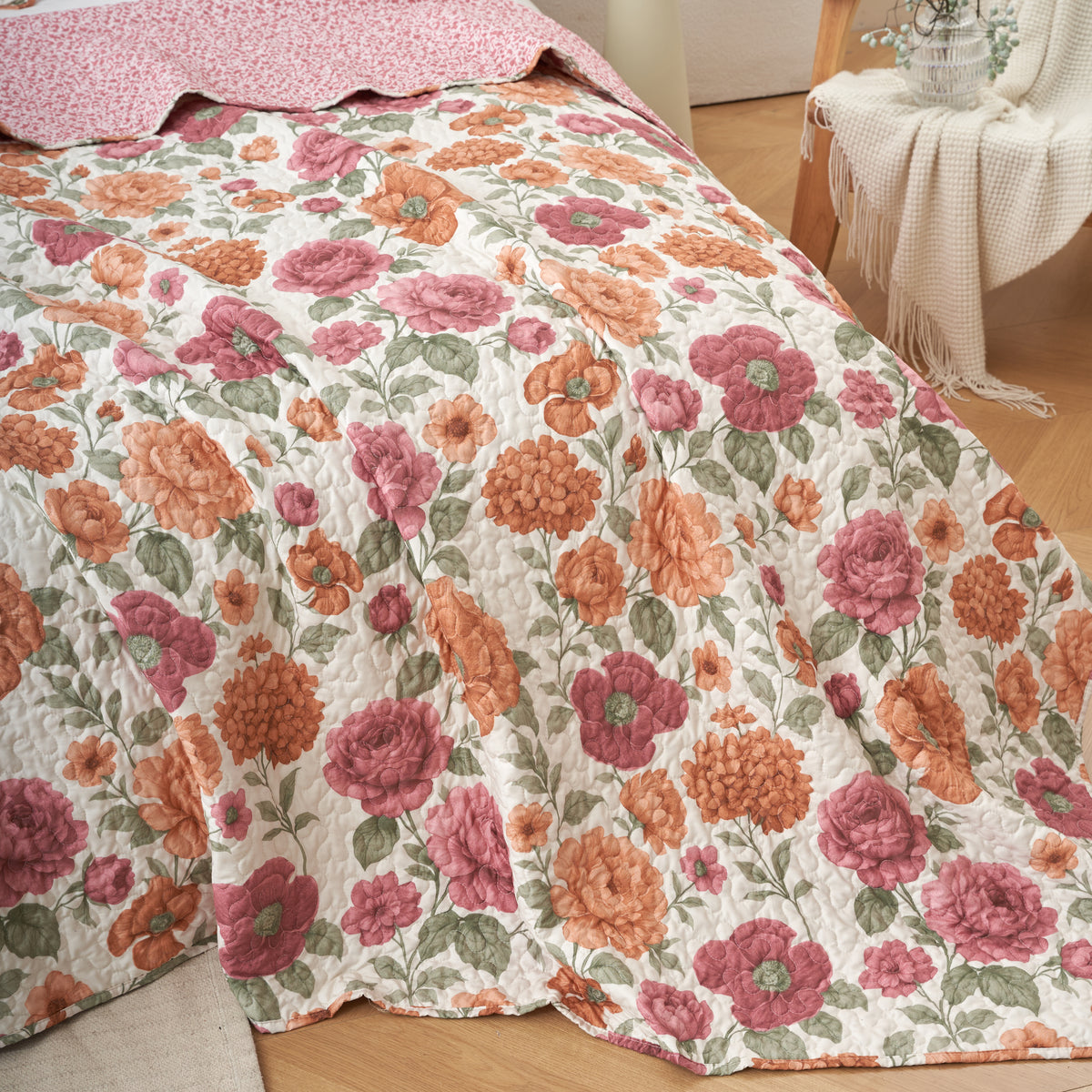 Close up of the soft microfiber texture and quilted stitching on the terracotta rose floral bedspread