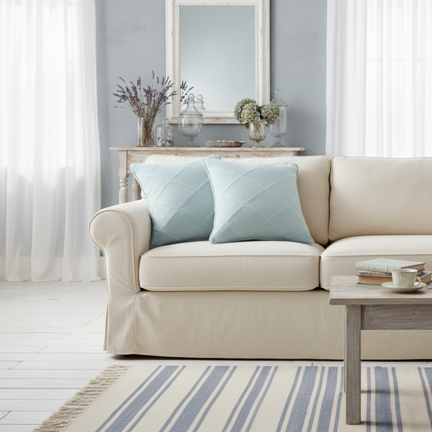 Beige sofa with light blue pillows in a living room setting.