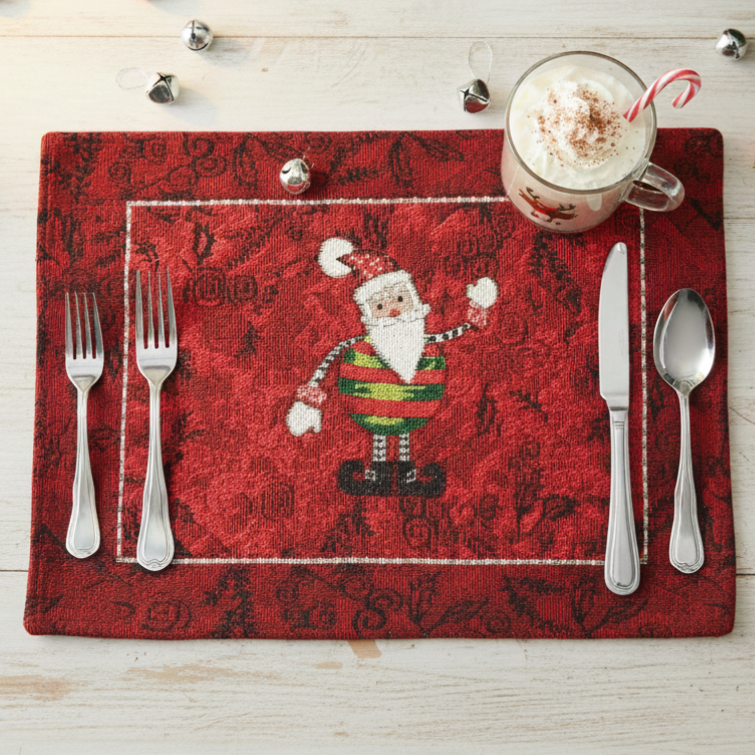 Tache Tapestry Red Santa placemat with cutlery and a mug on a wooden surface