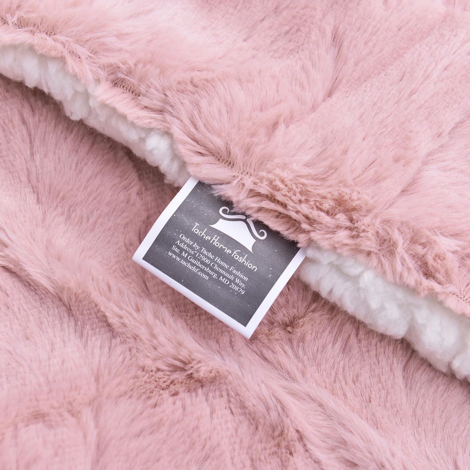 A luxurious pink satin blanket with a plush pink fleece reverse. The blanket is gently rumpled, inviting snuggles