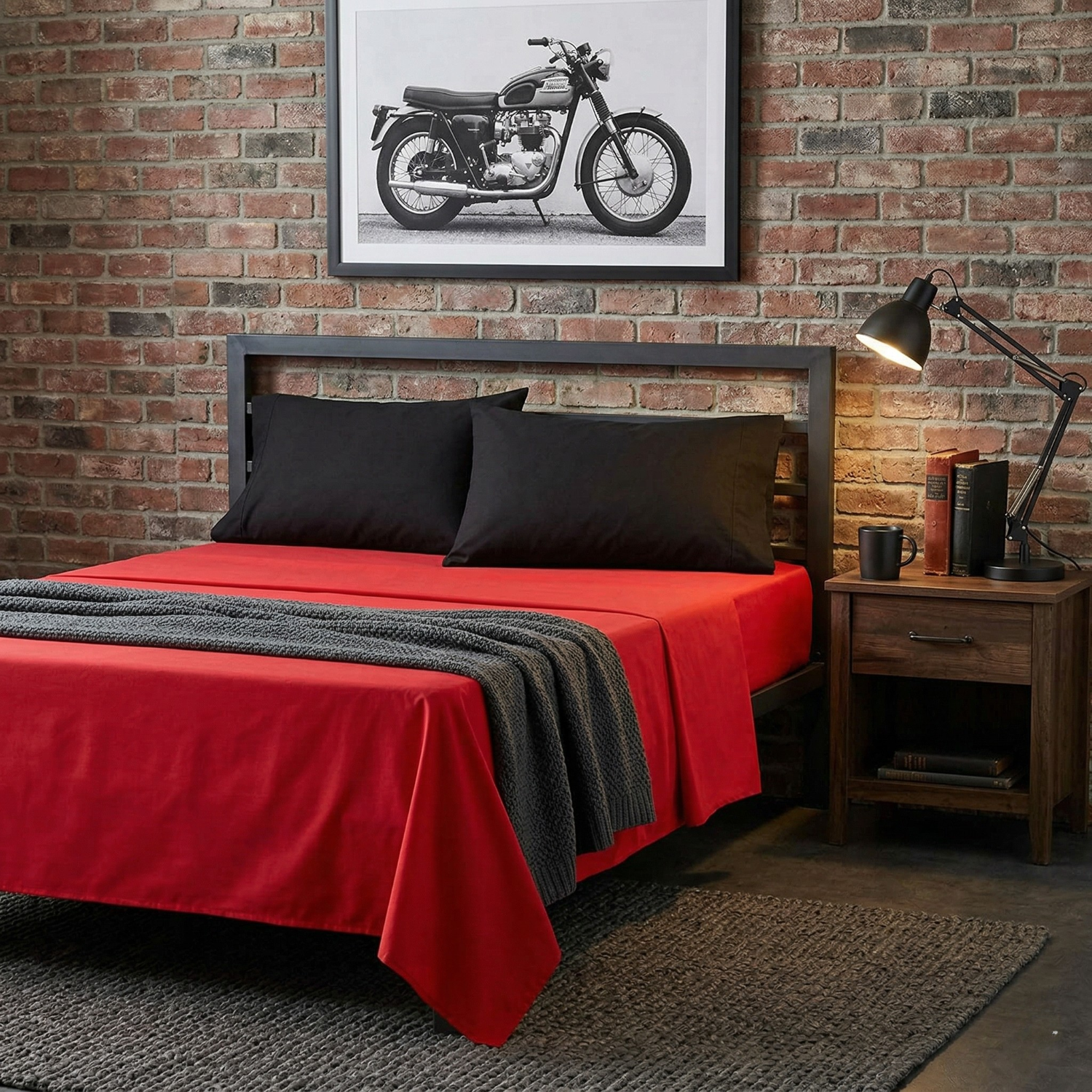 Vibrant red 100% cotton bed sheets with contrasting black pillowcases displayed in a modern industrial bedroom