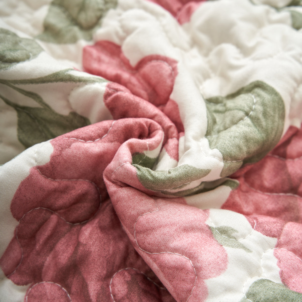 Quilted stitching and floral print detail on the Tache Terracotta Rose Garden bedspread