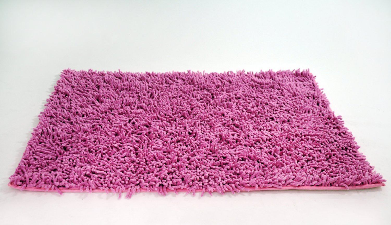 A pink chenille cotton shag bathroom rug. The rug is plush and fluffy, with an anti-slip backing to prevent slips and falls in the shower or tub. It is an absorbent bath mat that quickly soaks up water to keep bathroom floors dry. The rug is machine washable and resistant to water and stains. It is a small, soft, and super comfortable rug that adds a girly touch to any bathroom decor.